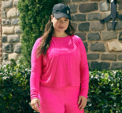 model is wearing a pink long sleeve pullover and pink high-waisted midi leggings. 
