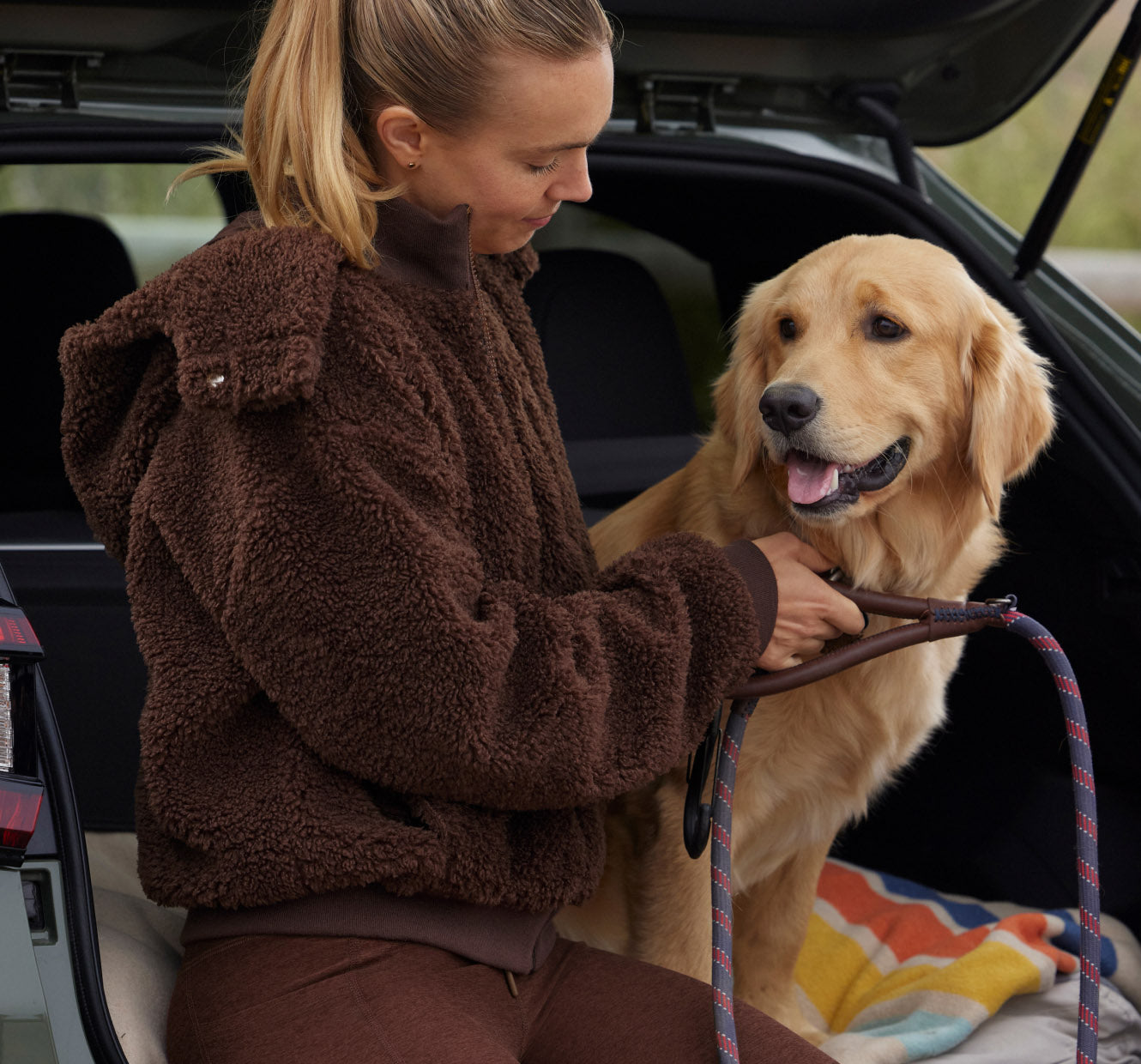 brown high-pile fleece jacket and brown high-waisted midi leggings. 