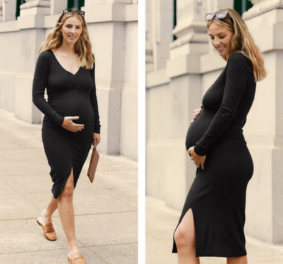 model is wearing a black midi maternity dress with a front slit. 