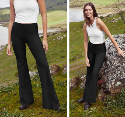 model is wearing a white high neck cropped tank and mid-rise black pants. 