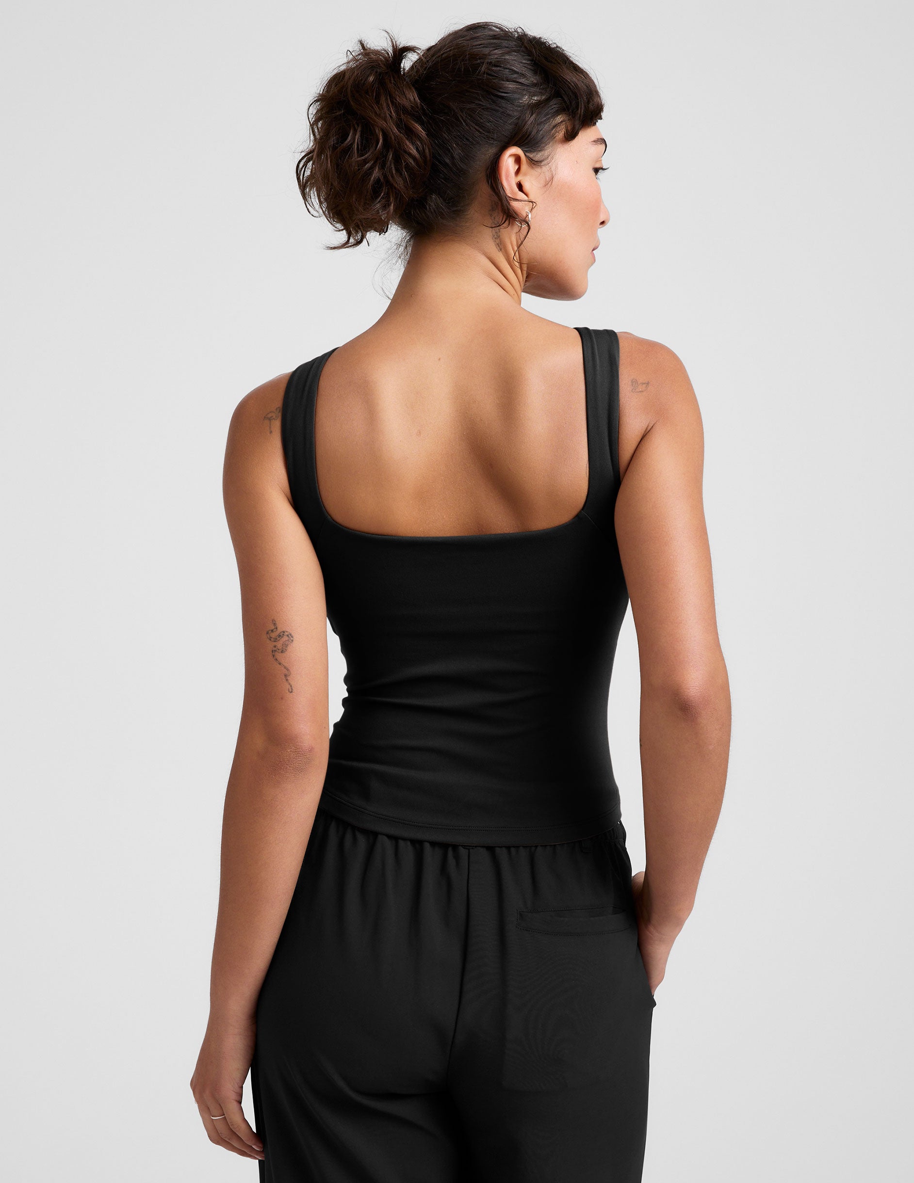 black boat neck tank top with a square back neckline. 