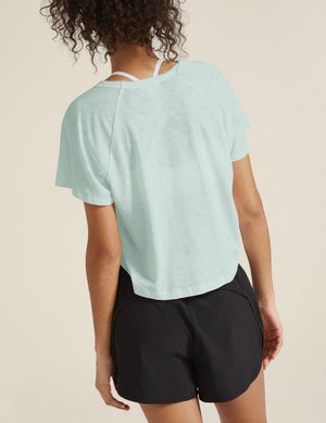 blue crew neck short sleeve high low cropped tee. 