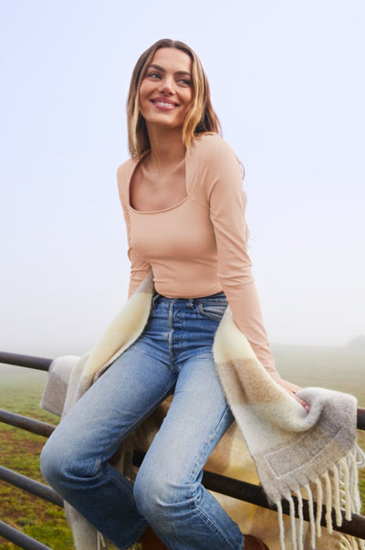 model is wearing a pink long sleeve heather rib square neck top. 