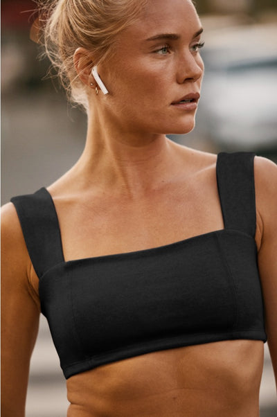 model is wearing a black square neck bra top. 