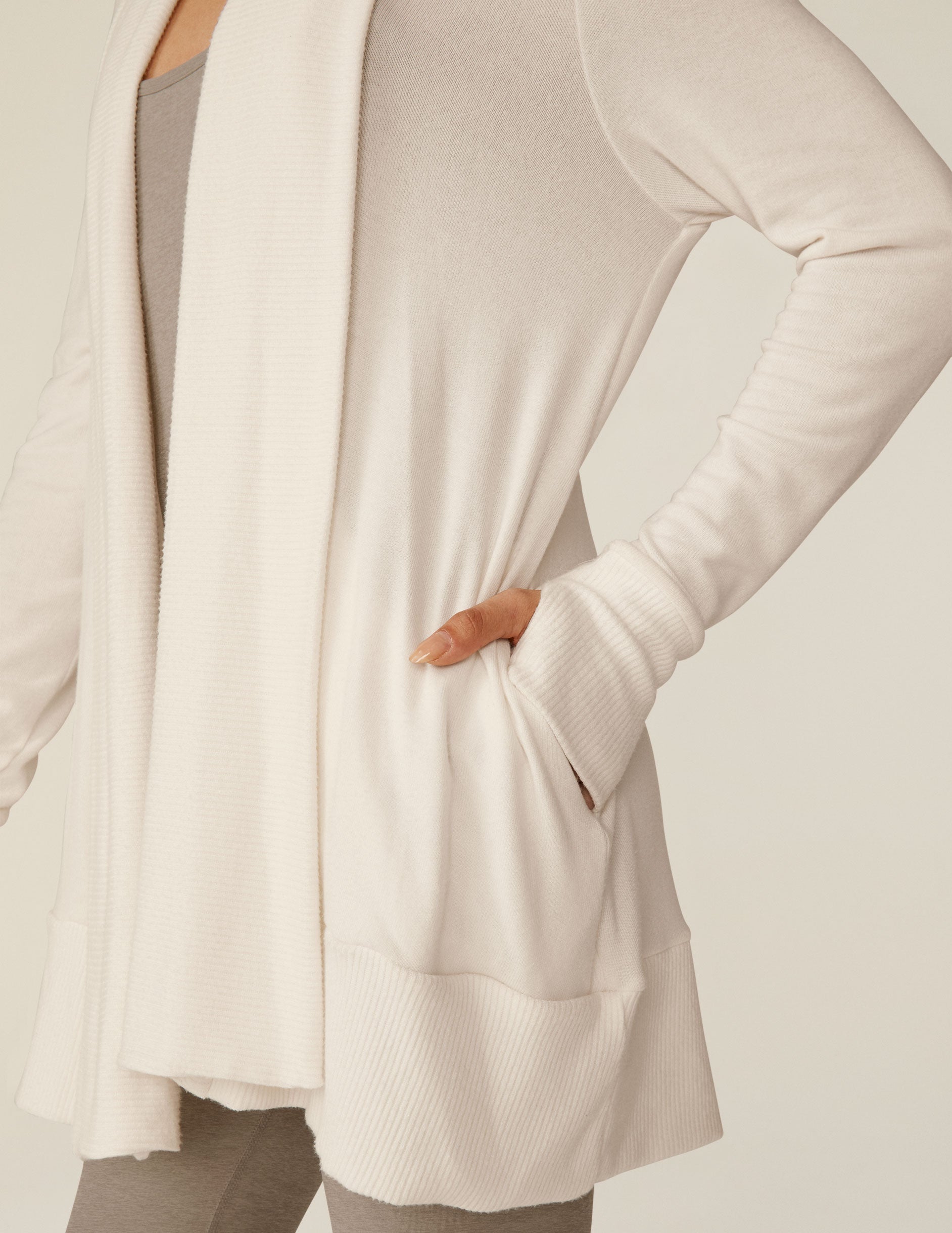 white cardigan with thumb holes