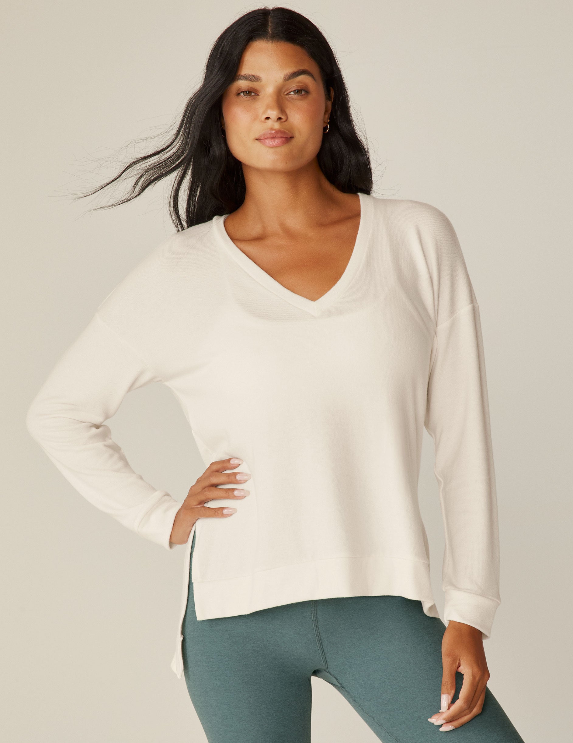 white v-neck pullover sweater with a high low hem. 