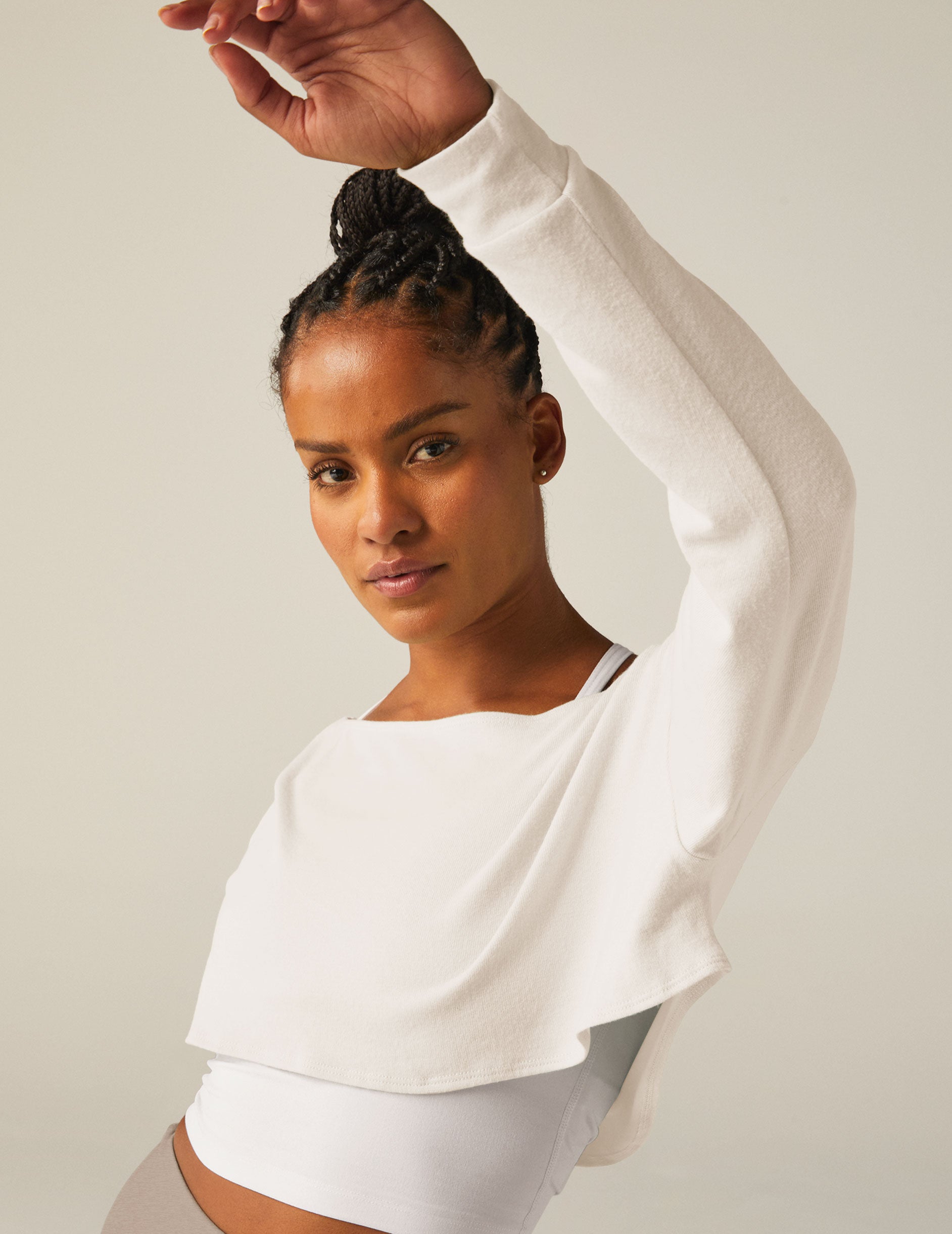 white off the shoulder shrug long sleeve top with a key hole detail. 