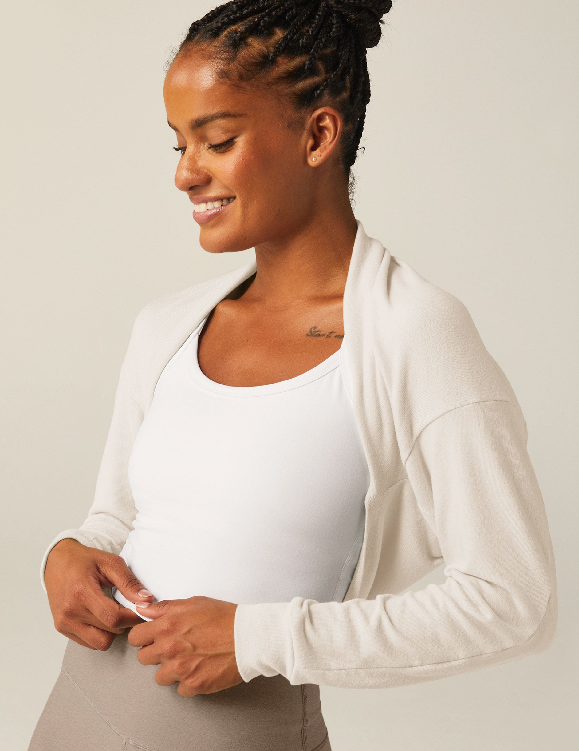 white off the shoulder shrug long sleeve top with a key hole detail. 