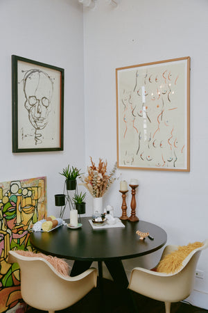 Claire's table with artwork hanging above