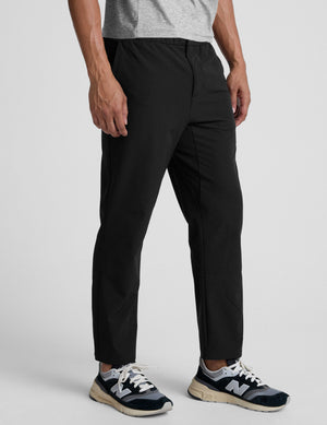 man wearing black pants on a plain background. 
