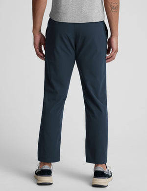 Rear view of the navy Dynamic Men's Straight Leg Pant featuring a relaxed fit and straight silhouette on a model.