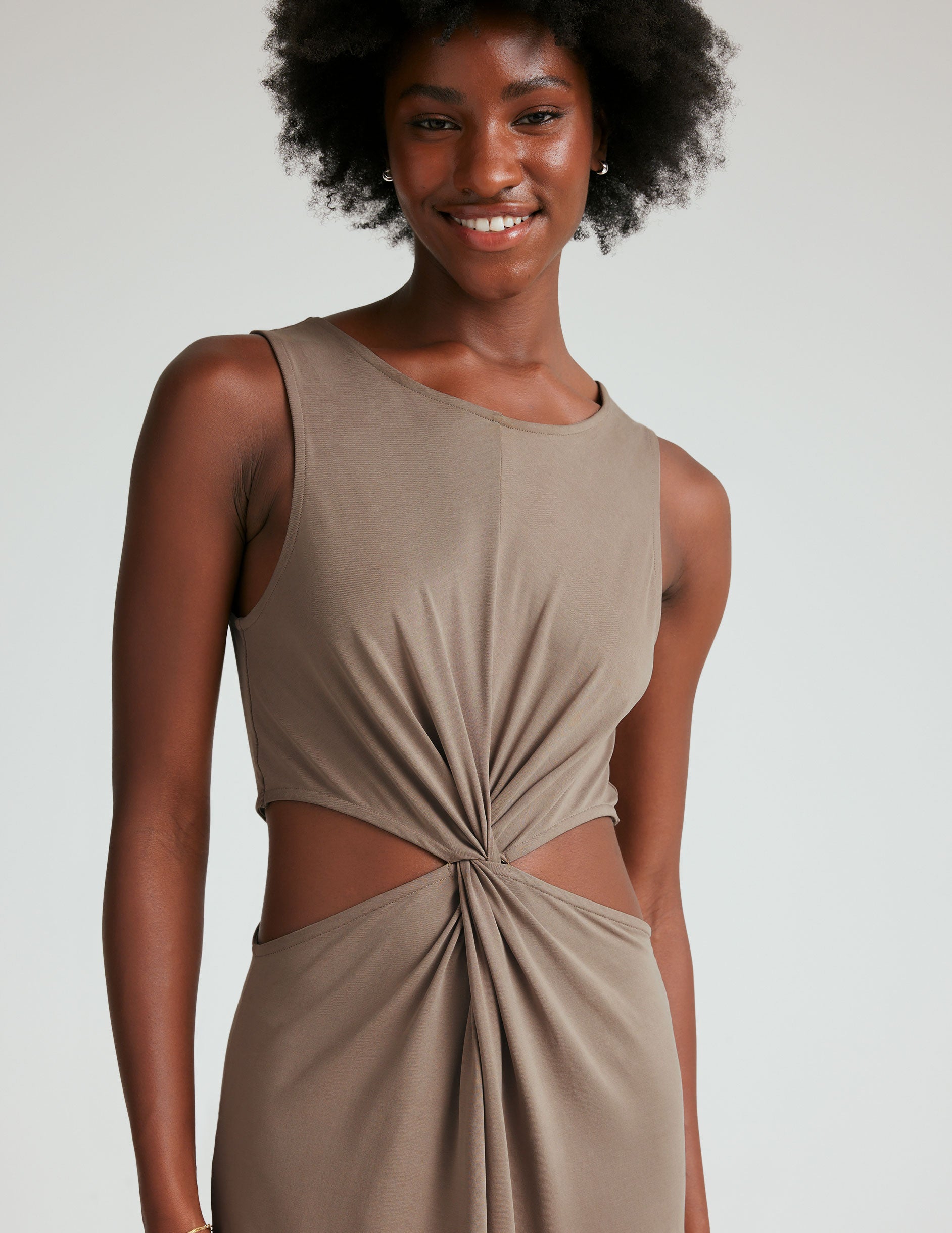 brown tank midi dress with cutouts and a twist detailing at waist and side slits. 