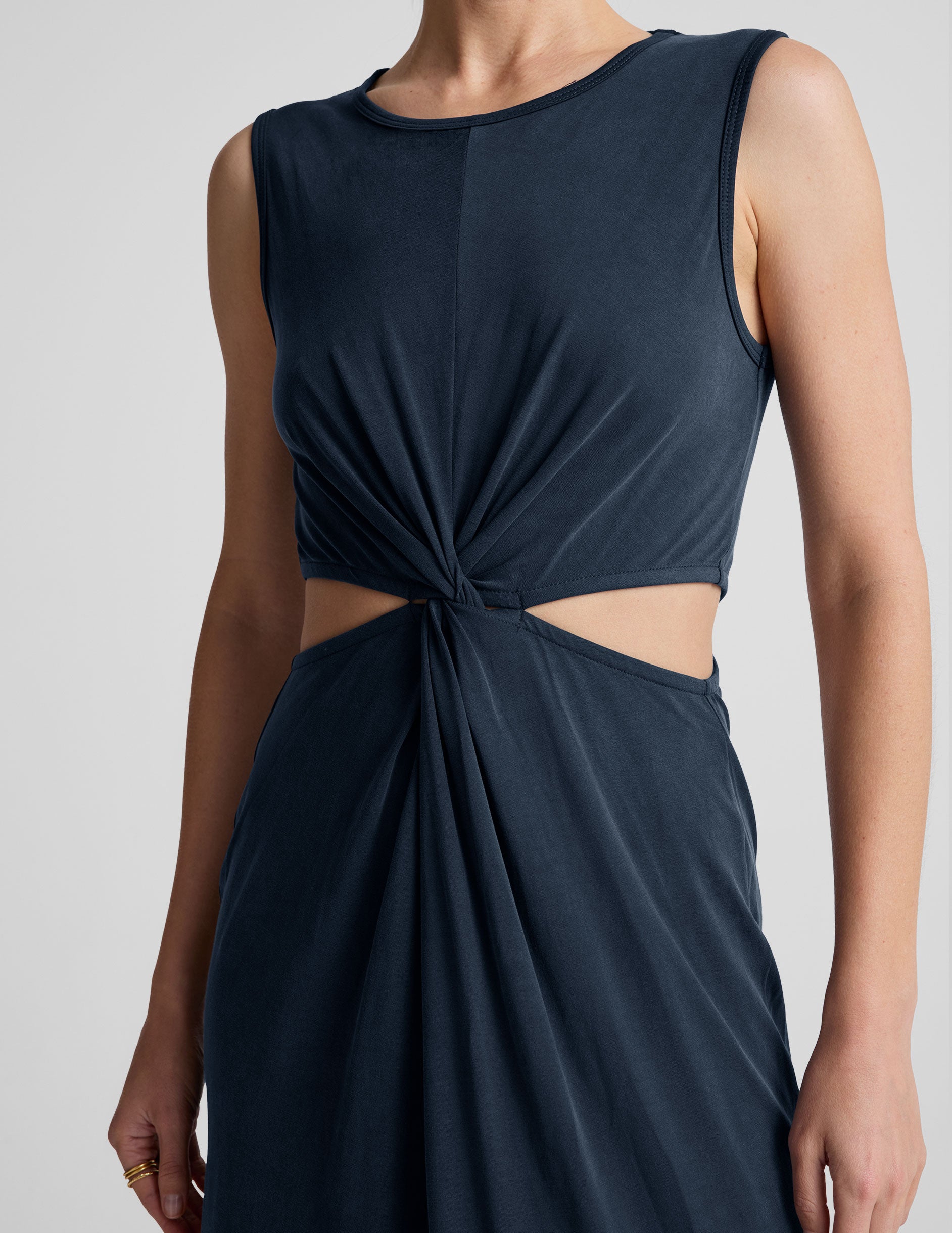 blue midi length thick strap tank dress with cutouts on sides of the waist and side slits on both sides of leg. 