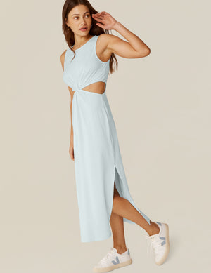 model is wearing a blue tank top maxi dress with a twist detailing and side cutouts. 