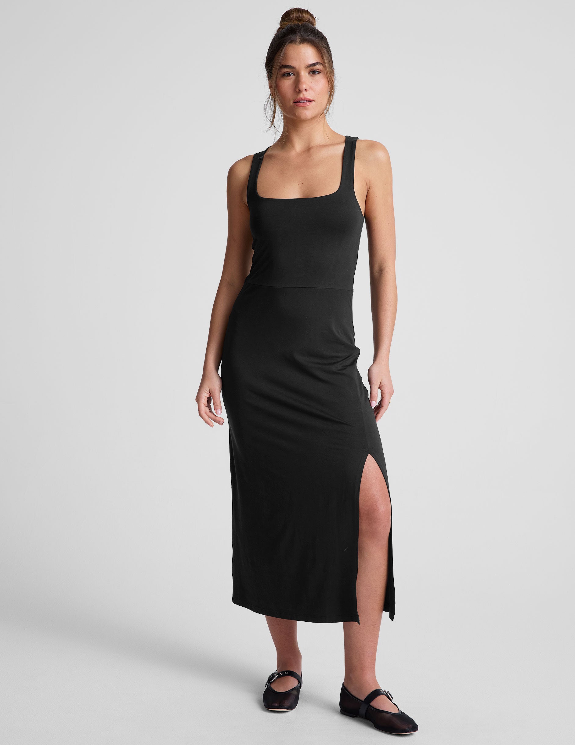 black midi dress with a square neckline and side slit. 