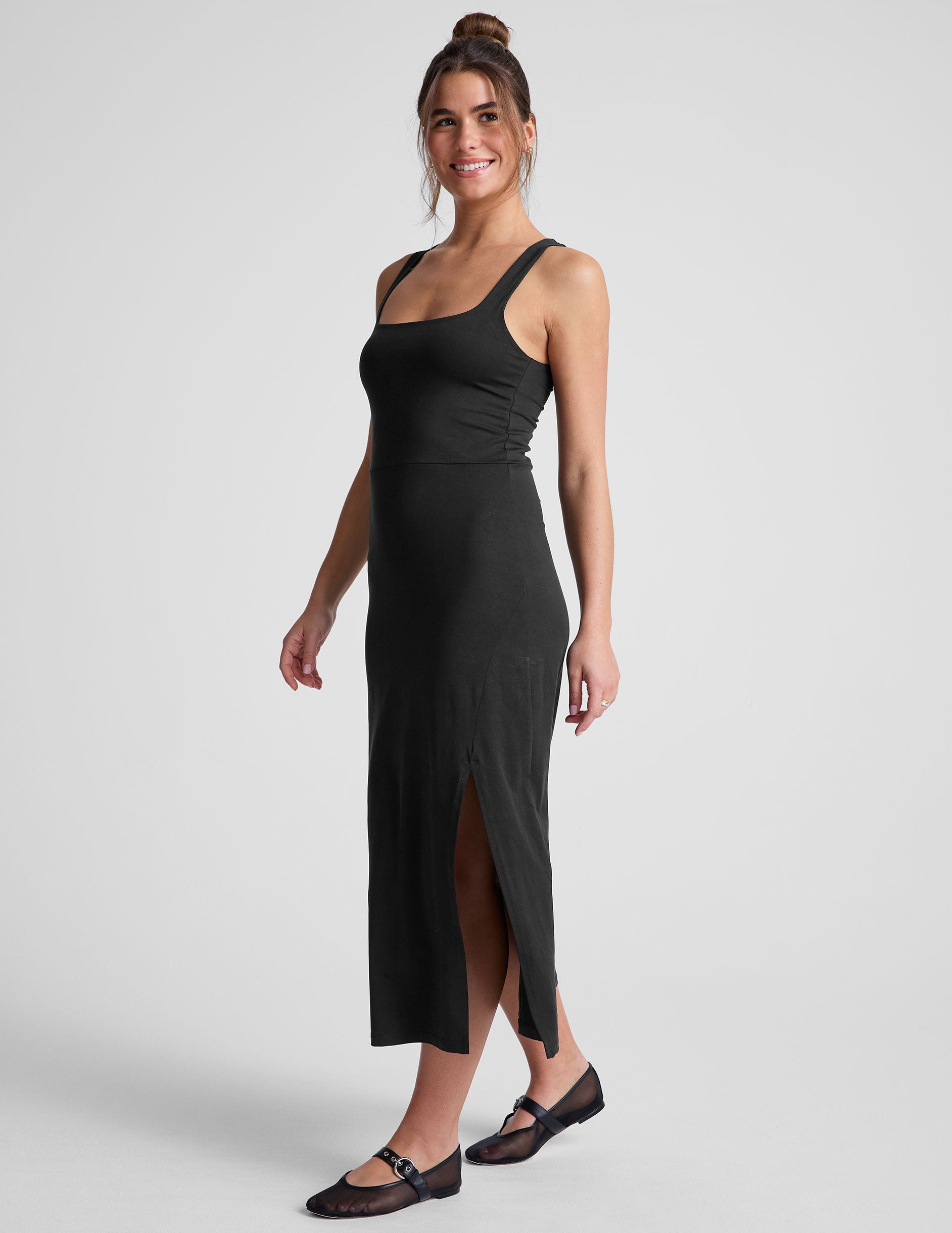 black midi dress with a square neckline and side slit. 