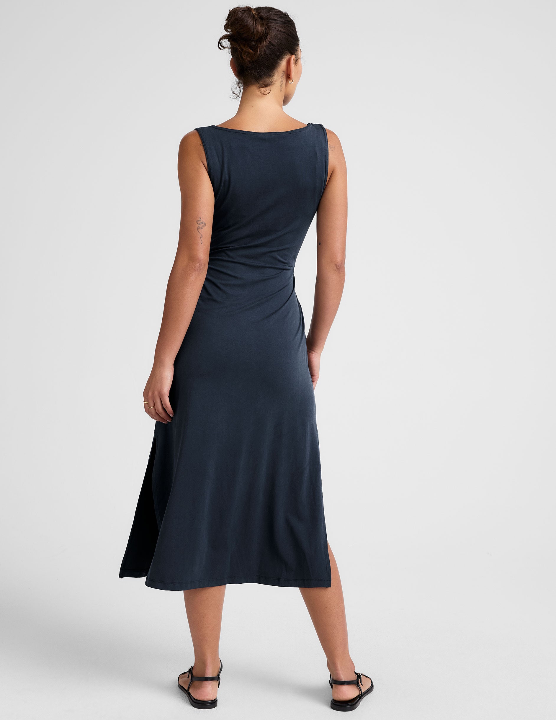 blue midi dress with a bateau neck and side twist. 