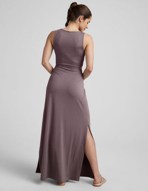 brown v-neck tank maxi length dress with cutouts at the waist. 