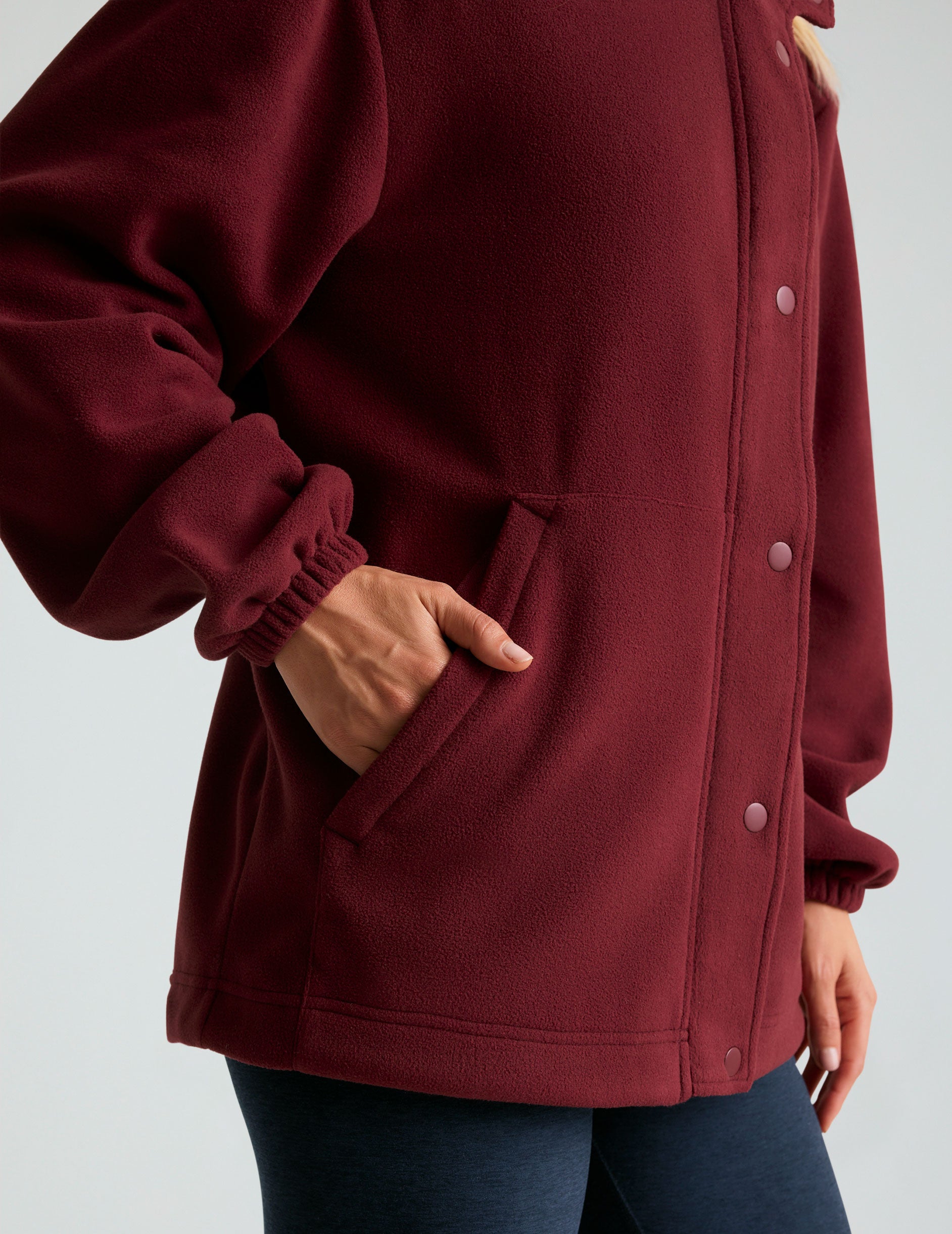 red fleece button up jacket with side pockets.