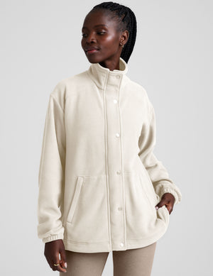 white fleece button up jacket with a full front zip and snap closures and pockets. 