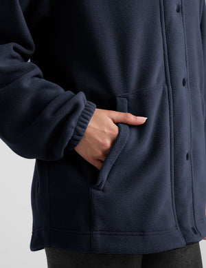 blue fleece button up jacket with a full front zip and snap closures and pockets. 