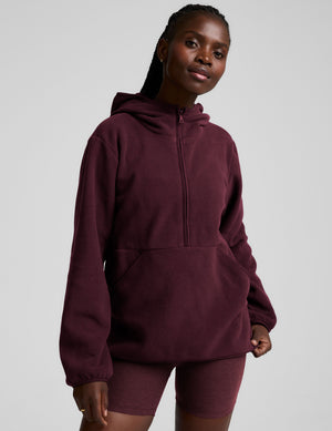 red fleece quarter zip jacket with a kangaroo pocket. 