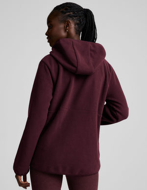 red fleece quarter zip jacket with a kangaroo pocket. 