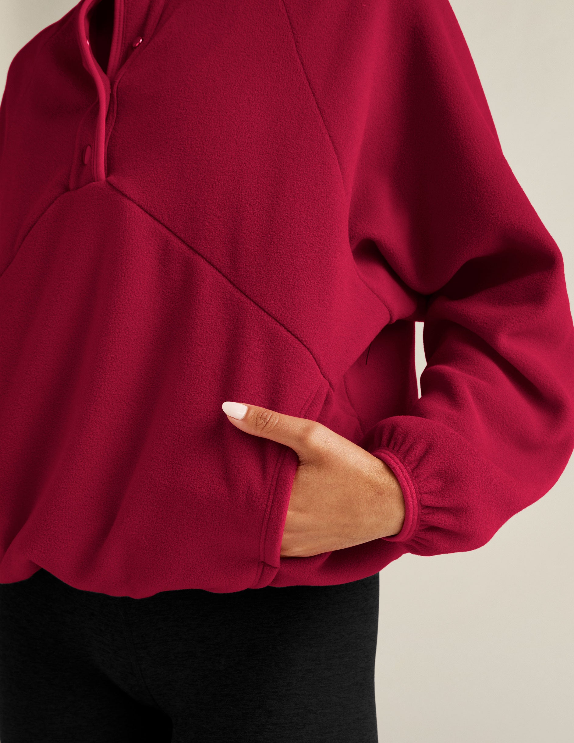 red pullover with quarter buttons. 