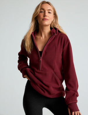 red fleece hooded quarter-zip pullover with a kangaroo pocket. 