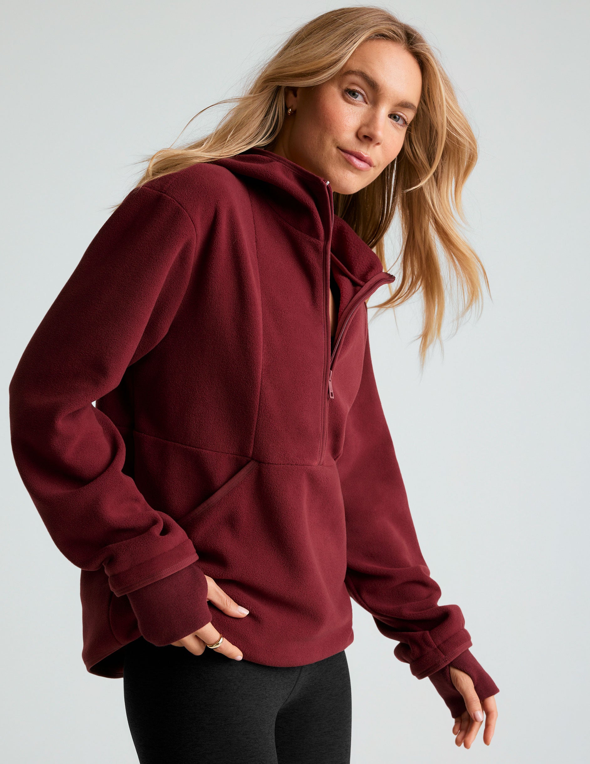 red fleece hooded quarter-zip pullover with a kangaroo pocket. 