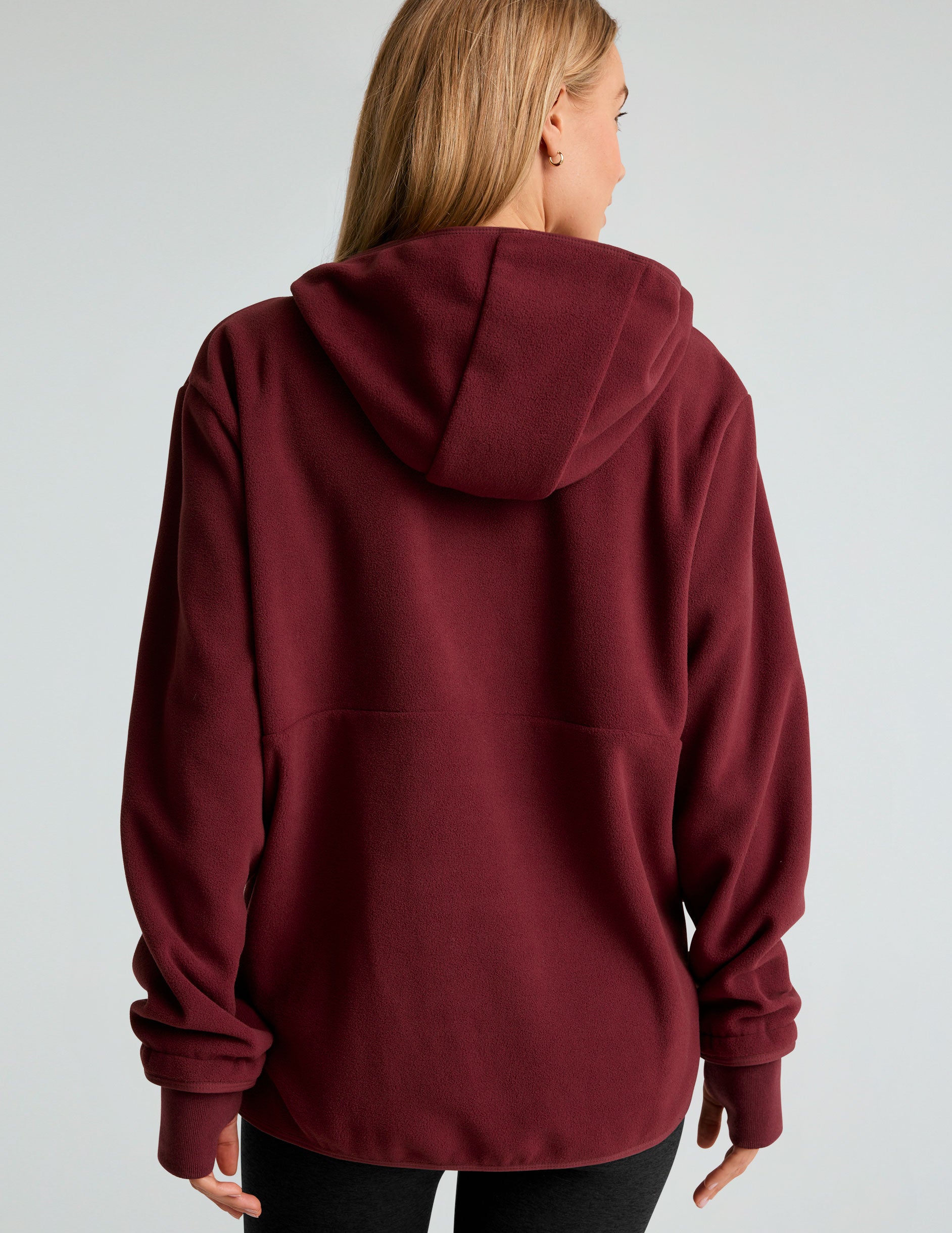 red fleece hooded quarter-zip pullover with a kangaroo pocket. 