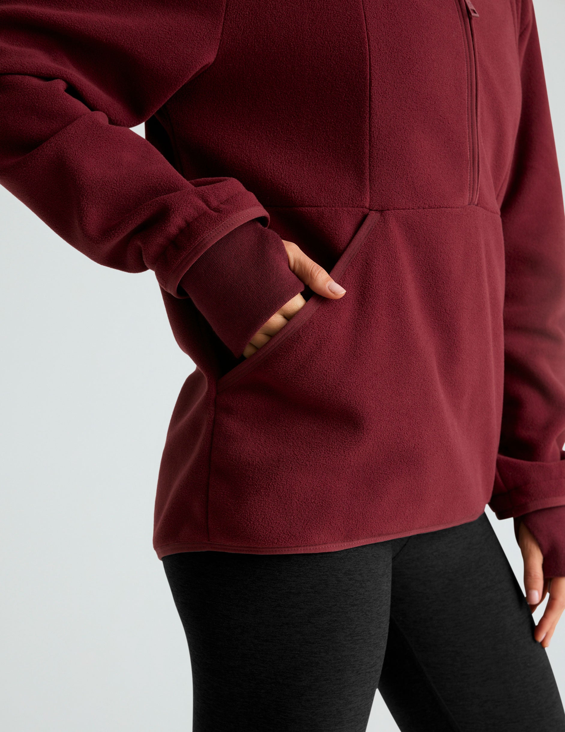 red fleece hooded quarter-zip pullover with a kangaroo pocket. 