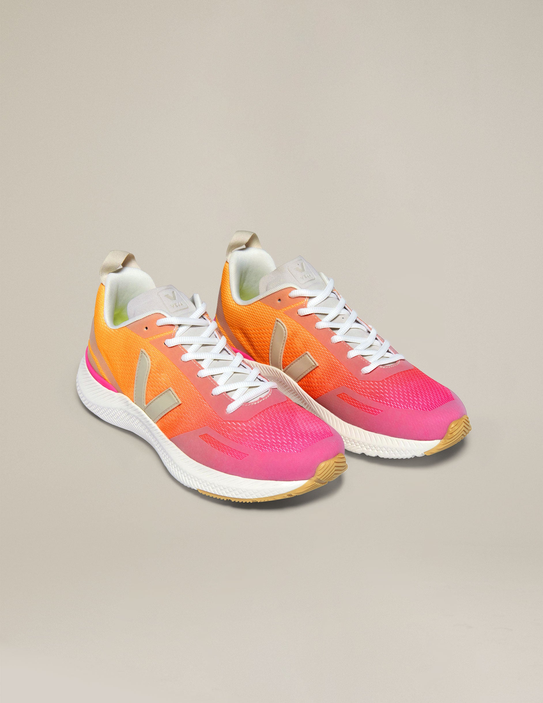 orange and pink lace up sneakers from Veja.