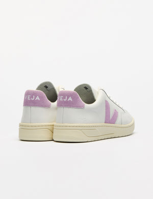 white low top VEJA sneakers with a purple logo detailing. 