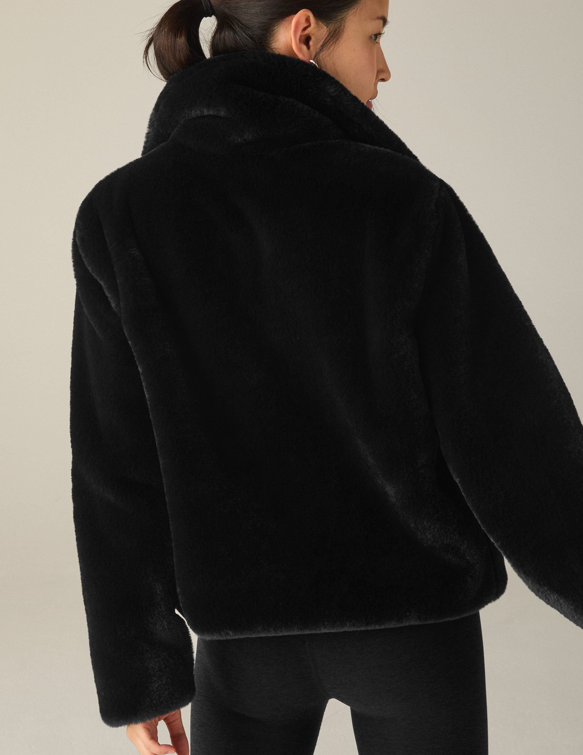 black faux fur zip-up collared jacket. 