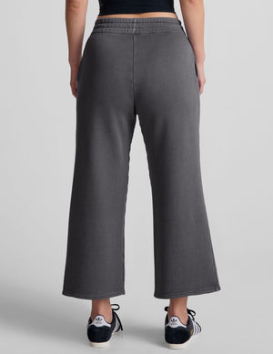 Back view of the dark gray Cali Wide Leg Cropped Pant, featuring a relaxed fit, wide legs, and an elastic waistband.