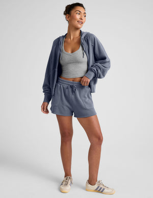 blue zip-up jacket with pockets and a hoodie. 