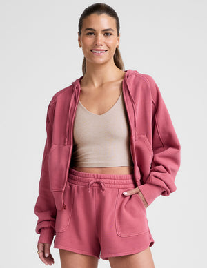red garment dyed zip-up sweatshirt with pockets. 