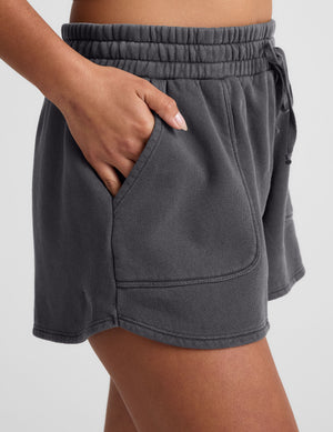 black shorts with patch pockets and a drawstring at waistband. 