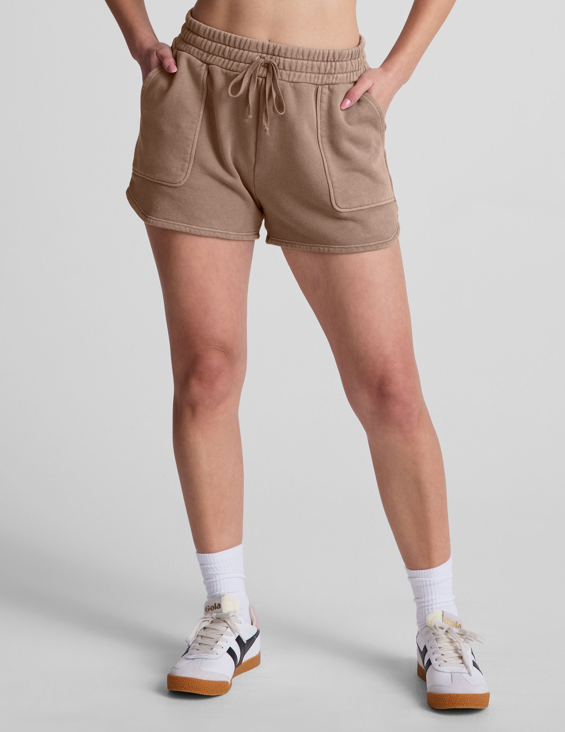 brown shorts with patch pockets and a drawstring at the waistband. 