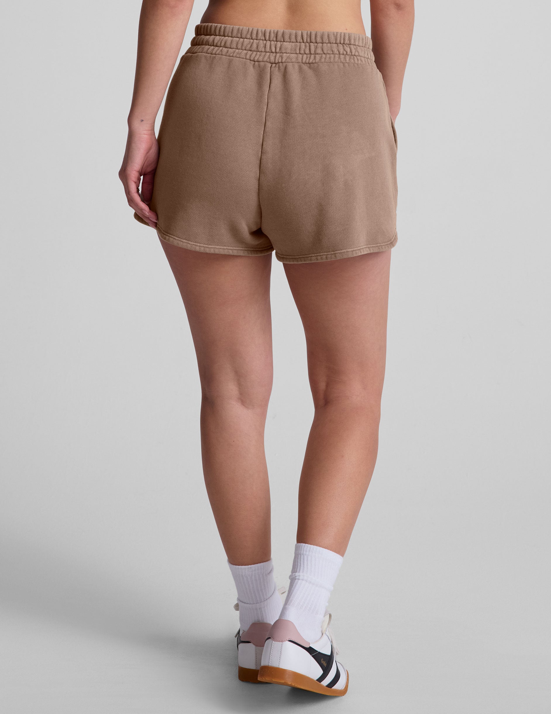 brown shorts with patch pockets and a drawstring at the waistband. 