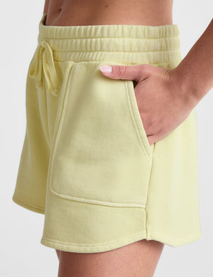 yellow terry shorts with pockets and a drawcord at waist. 