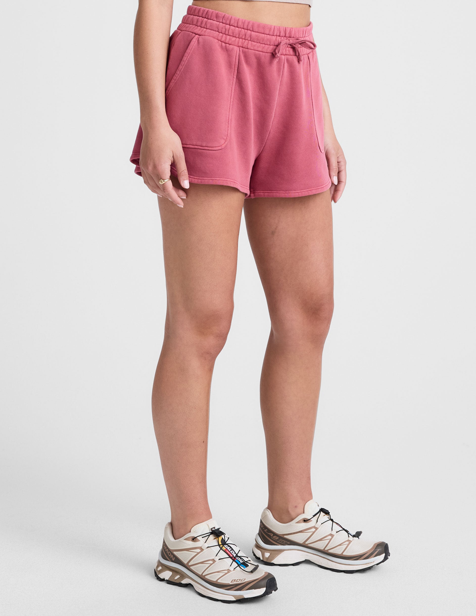 red terry shorts with pockets and a drawcord at waistband. 