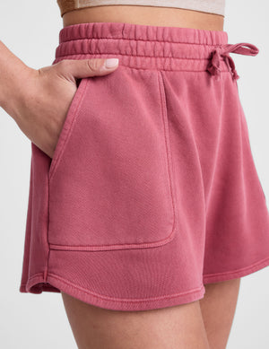 red terry shorts with pockets and a drawcord at waistband. 