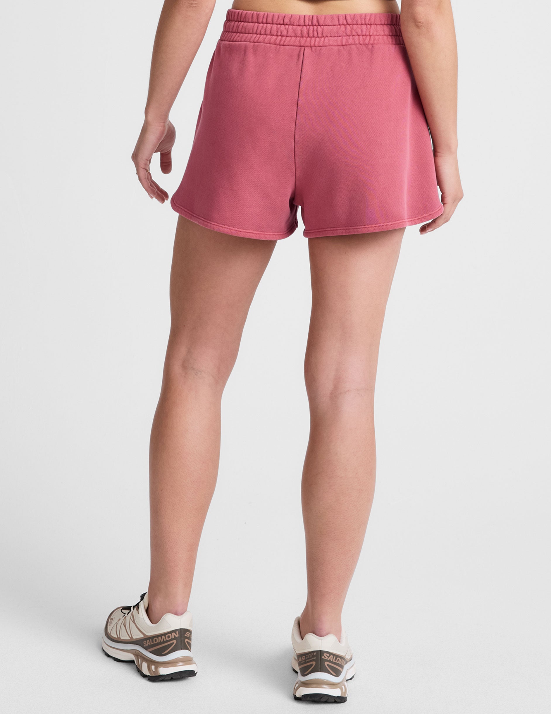 red terry shorts with pockets and a drawcord at waistband. 