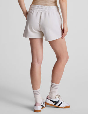 white relaxed fit terry shorts with patch pockets. 
