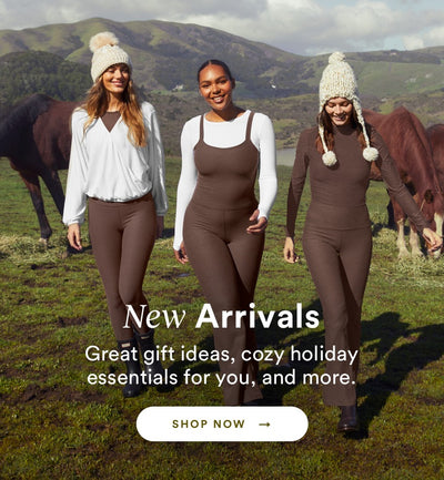 model on the left is wearing a white wrap long sleeve pullover and brown high-waisted midi leggings. the model in the middle is wearing a white long sleeve top and a brown flare pant jumpsuit. the model on the right is wearing a brown long sleeve t-shirt and brown high-waisted bootcut leggings.