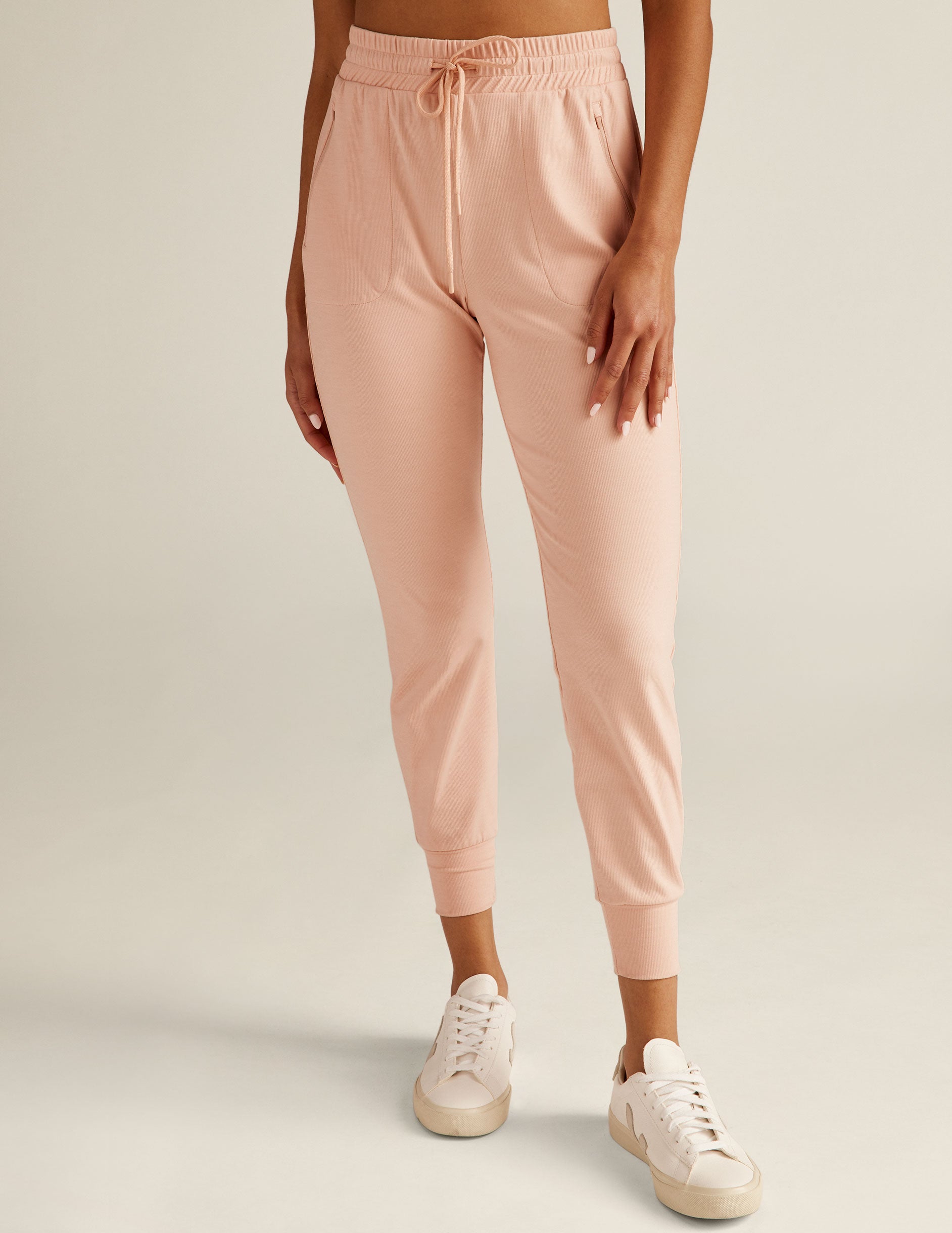 pink high-waisted midi joggers with pockets and a drawstring at waistband. 