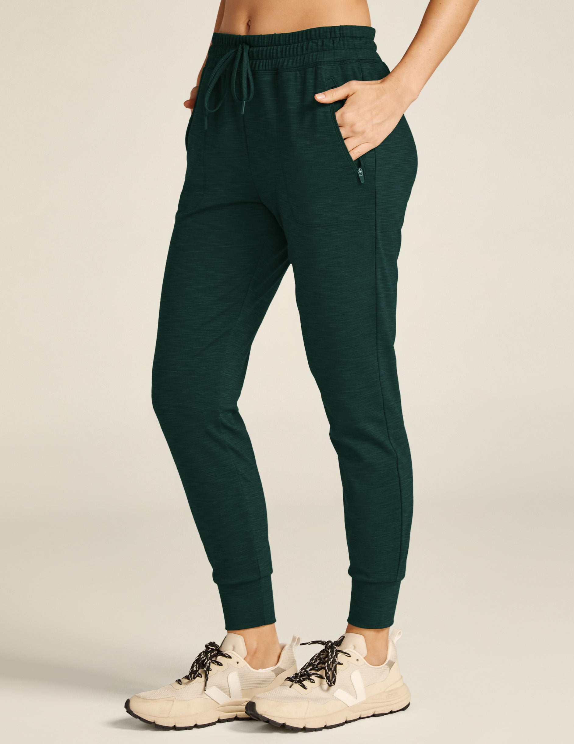 green midi length joggers with pockets. 