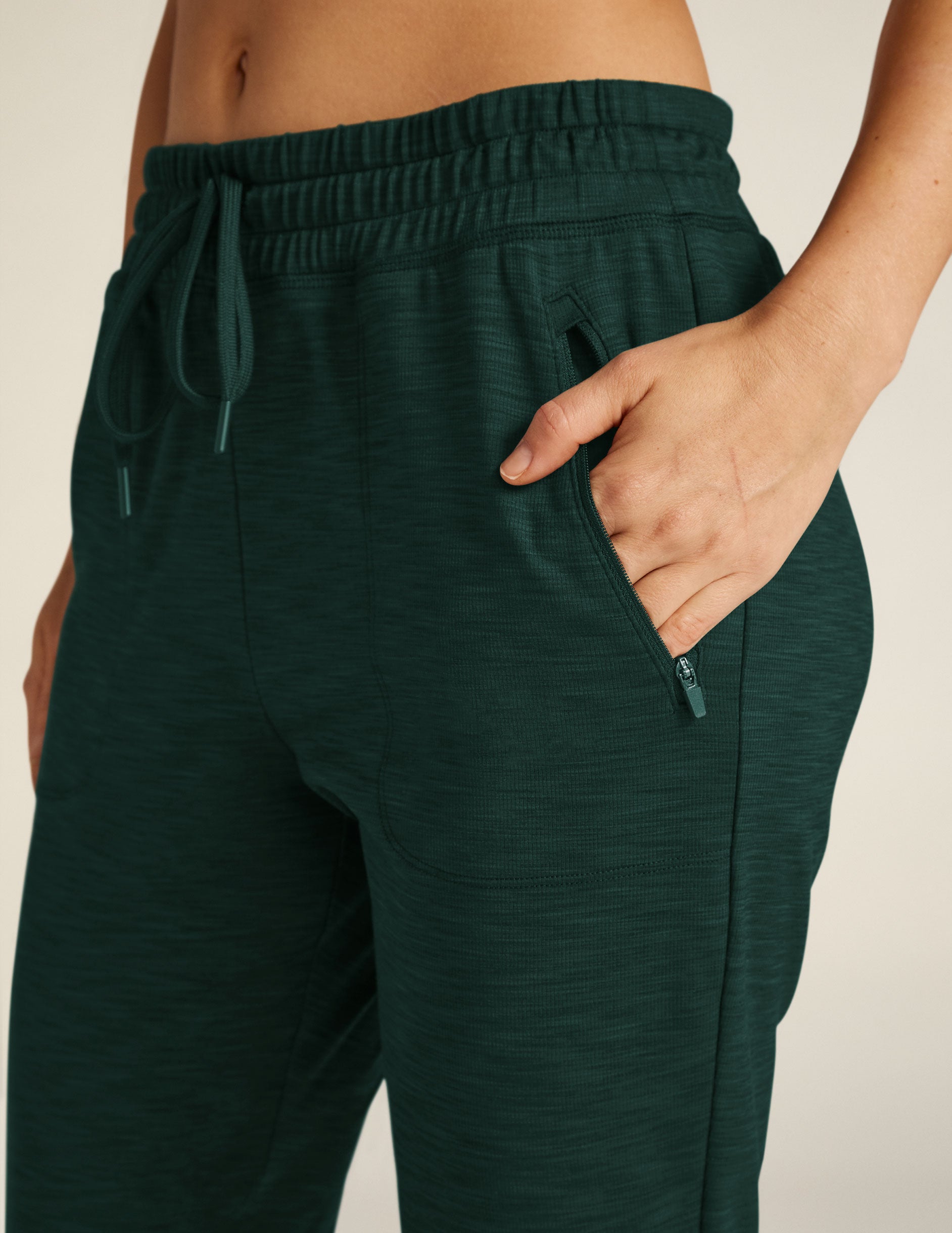 green midi length joggers with pockets.